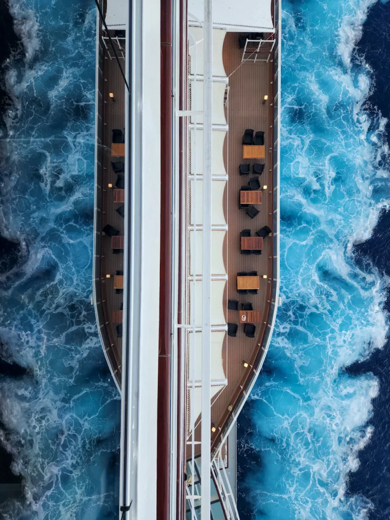 Looking down at the lower deck of our cruise ship with the reflection of the water on our balcony